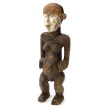 Tribal Art. An African female fertility figure, the face part stained red and painted in white, 62cm