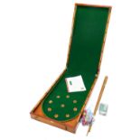A late 19thC Hamleys, Regent Street bagatelle game, in a mahogany case, 91cm long.