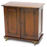 A late 19th/ early 20thC mahogany smokers type cabinet, with two panelled doors enclosing a vacant