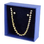 A Swarovski crystal necklace and earring set, set in yellow coloured setting, and numbered