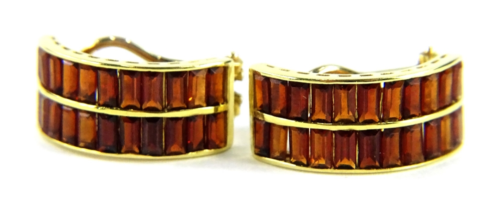 A pair of 18ct gold garnet set half hoop earrings, each set with two rows of baguette cut garnets,