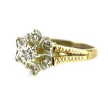 A 9ct gold dress ring, set with illusion set tiny diamonds in a central cluster setting, with two