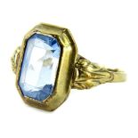 An aquamarine set signet ring, with single rectangular cut stone, on layered setting, with scroll