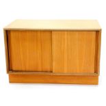 A G-Plan type teak TV cabinet, with two plain doors on a plinth base, 48cm high, 76cm wide, (AF).