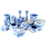 A quantity of blue Wedgwood Jasperware, to include a pair of candlesticks, boxes and covers, two