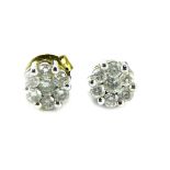 A pair of diamond cluster earrings, each cluster set with seven round brilliant cut diamonds in claw