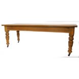 An oak kitchen table, the planked and cleted top above a moulded frieze on turned tapering legs,