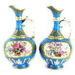 A pair of 19thC Sevres style ewers, each painted with baskets of flowers within an elaborate