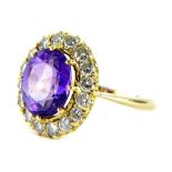 An amethyst and diamond dress ring, with oval cut amethyst 8.9mm x 10.4mm x 4.8mm, in an eight