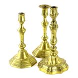A pair of continental brass candlesticks, each with a domed foot, 24cm high, and another continental