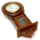 An early 20thC walnut wall clock, the painted dial with Roman numerals, the case with a glazed