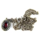 A silver plated paste stone and marquasite set pendant, in a silver plated frame on a costume