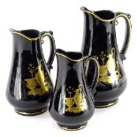 A graduated set of three 19thC jugs, decorated in the Etruscan style in gilt on a black ground,