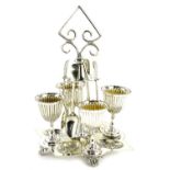 An Edwardian silver plated egg cruet set, with angular cylindrical handle, diamond shaped base,