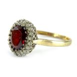 A 9ct gold dress ring, formed as a cluster with central oval cut garnet, surrounded by CZ stones,
