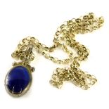 A stone set silver pendant and chain, the oval pendant set with jet one side and blue stone to the