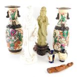 A Chinese porcelain blanc de chine figure of a lady, in flowing robes holding basket of leaves, on
