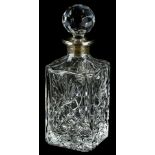 A 20thC cut glass decanter of shouldered form, with a repeat geometric hobnail cut, floral pattern