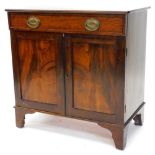 An early 20thC mahogany side cabinet, the top with rounded corners above a frieze drawer, and two