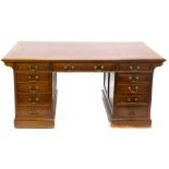 An early 20thC mahogany partners type pedestal desk, the rectangular top with a maroon leather inset