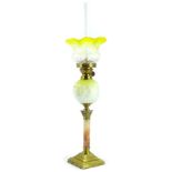 A Victorian brass oil lamp, with a small yellow and white frosted shade, brass fitting, the yellow