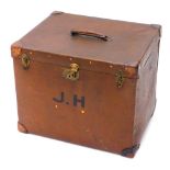 An Edwardian canvas trunk or storage box, with leather corners, the lid enclosing a fitted