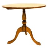 An oak occasional table, the circular top on a turned column and tripod base, 81cm diameter.