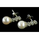 A pair of 18ct white gold diamond and cultured pearl drop earrings, each earring with three tier