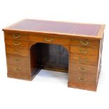 *A mahogany kneehole desk, the rectangular top with a brown maroon leather inset and a reeded