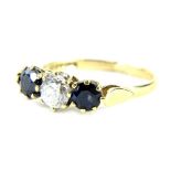 A 9ct gold three stone dress ring, with two dark blue stones and central CZ, ring size L, 2.1g all