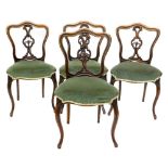 A set of four Victorian rosewood balloon back chairs, each with a shaped back, a pierced splat and a