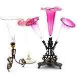 A Victorian Brittania metal epergne, with cranberry tinted trumpet shaped vases, on a shaped base,