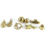 Eight 9ct gold charms, comprising an L circular charm, two footballs, a dolphin, a bell, a koala,