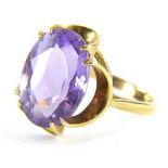 A 9ct gold amethyst dress ring, with oval amethyst in twin four claw setting, and waved design