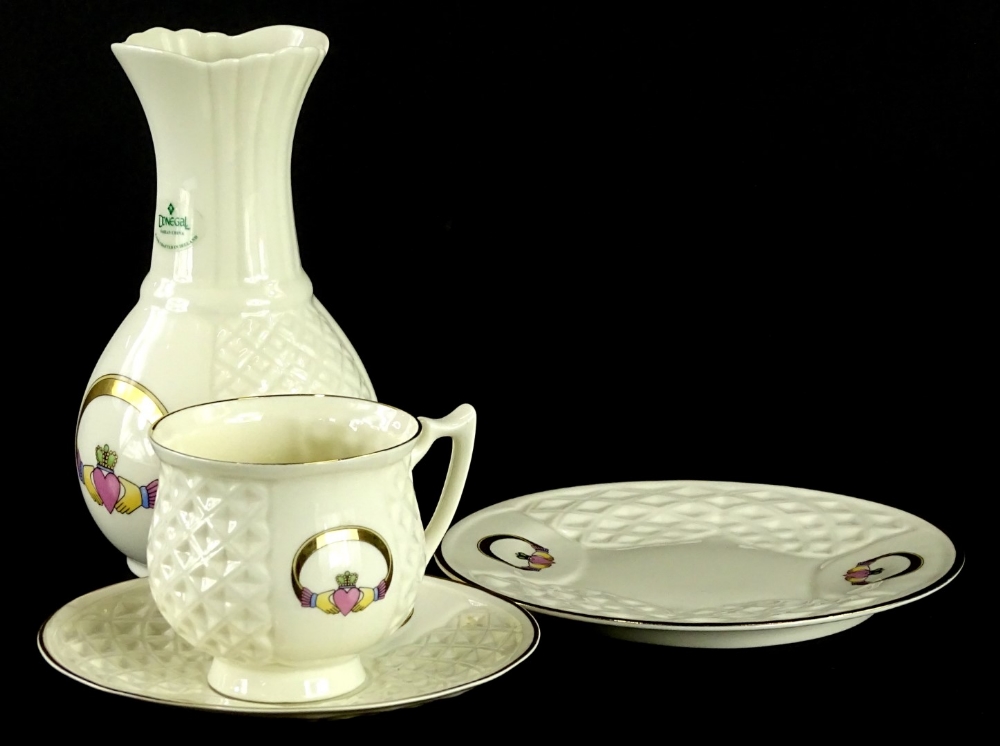 Four items of Donegal Belleck Claddagh pattern, to include a vase, cup and saucer, and a side