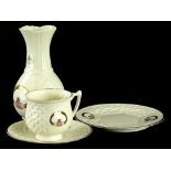 Four items of Donegal Belleck Claddagh pattern, to include a vase, cup and saucer, and a side