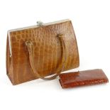 A brown crocodile type leather ladies handbag, with silver plated mounts, etc., and an associated