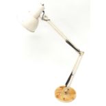 A cream painted Anglepoise reading lamp, on a metal base, 114cm high. (AF)