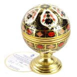 A Royal Crown Derby porcelain Millennium globe thermometer, the hinged lid decorated with the motto,