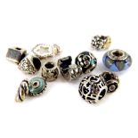 Ten Pandora charms, comprising a pierced ball, flower posy, roses, stars, house, heart, breaker