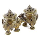 A pair of continental bronze pot pourri, each with a pierced lid, enclosing an internal candle