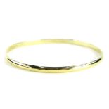 A 9ct gold bangle, with millennium hallmark, of plain polished design, diameter 6.5cm, 10.1g all in.
