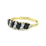 A 9ct gold dress ring, set with baguette cut dark blue stones, and CZ stones, ring size O, 1.9g