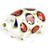 A Royal Crown Derby pig paperweight ornament, silver stopper, printed marks beneath, 13cm wide.