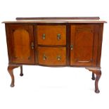 An early 20thC mahogany bow fronted sideboard, with two central drawers flanked by two panelled