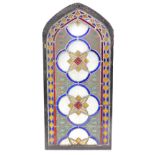 A 19thC stained glass arched window panel, decorated in the Gothic style with lozenges, flowers,