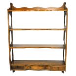 A mahogany wall shelf, with pierced sides and three small drawers, 69cm wide.