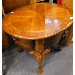 An oval occasional table, with wide crossbanding and quarter veneered top, on cabriole legs