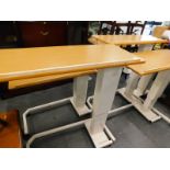 Five hospital bed tables, some adjustable, on shaped metal bases terminating in castors, 114cm high,