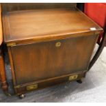 *A stained 20thC campaign style cabinet of rectangular form, with side carrying handles, flush front